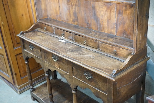 An 18th century style elm pot board dresser with boarded rack, length 132cm, depth 39cm, height 187cm